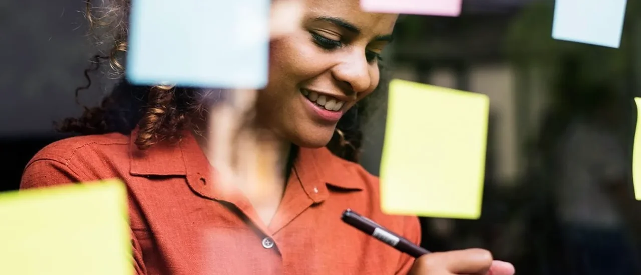 Brainstorming with post-its on a glass wall