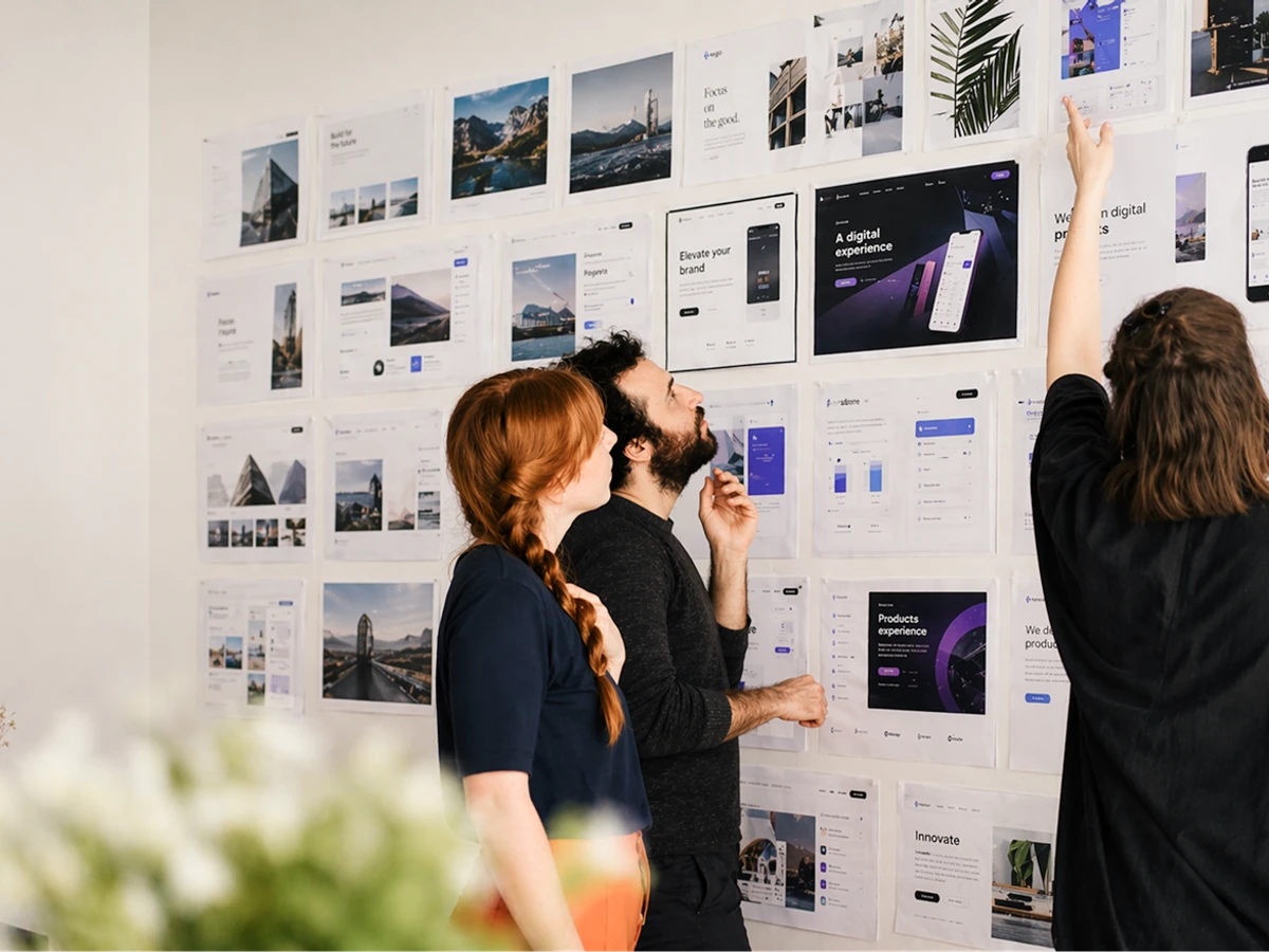 Team reviewing design boards on wall