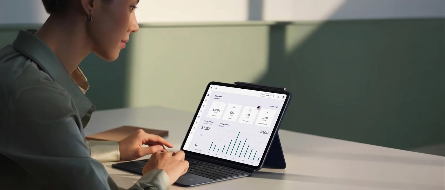 Woman reviewing a sales performance dashboard on a tablet